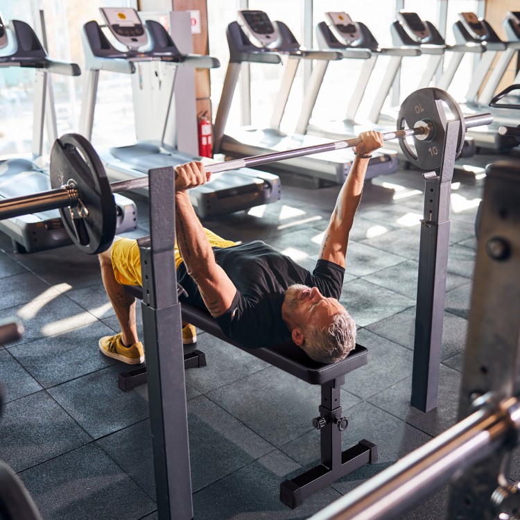 Weight bench with adjustable height, heavy-duty metal frame, and foam padding for versatile workouts in the gym.